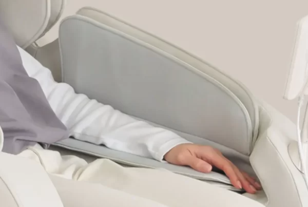 Close-up of the Inada iFIT PRO massage chair’s hand massage feature, showing air cushions gently compressing the hands for relaxation.