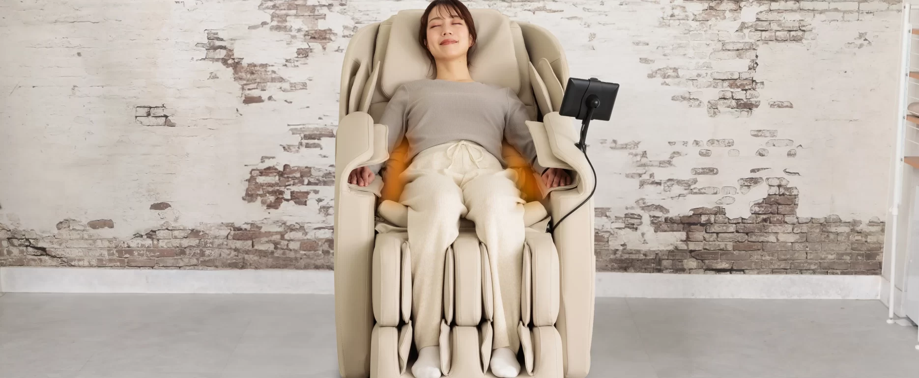 Inada iFIT massage chair showing integrated lumbar heating system for muscle relaxation and comfort